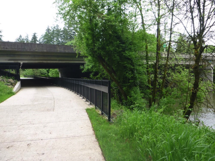 Hard surface trail under the Interstate 5 freeway - Tualatin River - iron fence  - security camera - lighting
